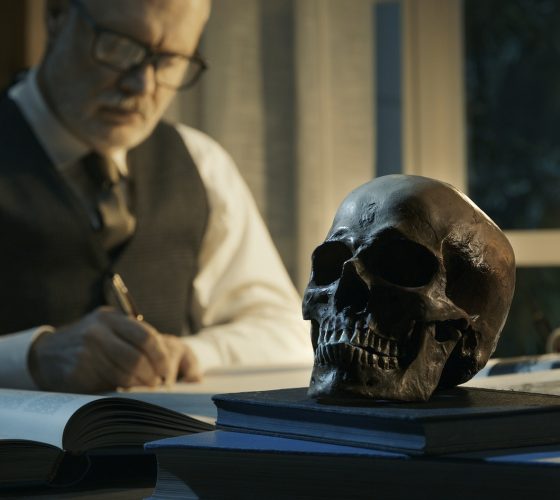 Academic professor studying a human skull